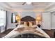 Spacious main bedroom with a tray ceiling, stylish decor, and elegant bedside lighting at 1547 Paxton Sw Dr, Lilburn, GA 30047