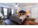 Spacious main bedroom boasts tray ceilings, hardwood floors, and elegant decor at 1547 Paxton Sw Dr, Lilburn, GA 30047