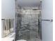 Bathroom featuring a glass-enclosed shower with marble tile surround and a rain shower head at 1547 Paxton Sw Dr, Lilburn, GA 30047