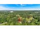 Aerial perspective highlighting the property with surrounding green canopy, house, and shed at 1731 Maryland Sw Ave, Marietta, GA 30008