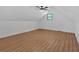 Attic space with sloped ceilings, window, and wood-look floor at 1731 Maryland Sw Ave, Marietta, GA 30008