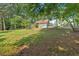 Spacious backyard showing the home exterior, including a large yard, shed, and partial fencing at 1731 Maryland Sw Ave, Marietta, GA 30008