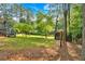Expansive backyard features mature trees, a shed, and a charming deck, perfect for outdoor gatherings and relaxation at 1731 Maryland Sw Ave, Marietta, GA 30008