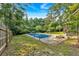 Spacious backyard with inviting pool, slide, lush greenery, and mature trees creating a private and tranquil outdoor space at 1731 Maryland Sw Ave, Marietta, GA 30008