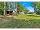 Wide shot of the expansive backyard with shed and mature trees, showcasing the property's outdoor space at 1731 Maryland Sw Ave, Marietta, GA 30008