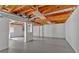 Unfinished basement featuring painted floors, exposed wood ceiling and support beams, awaiting your creative design ideas at 1731 Maryland Sw Ave, Marietta, GA 30008