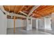View of unfinished basement featuring painted floor and exposed ceiling with visible beams, ducts and utility components at 1731 Maryland Sw Ave, Marietta, GA 30008