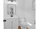 Modern half-bathroom with a sleek mirror, vanity, and toilet at 1731 Maryland Sw Ave, Marietta, GA 30008