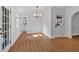 Bright dining room featuring hardwood floors, a modern chandelier and a view of the bathroom at 1731 Maryland Sw Ave, Marietta, GA 30008