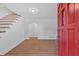 Inviting entryway with wood floors, red door, and staircase at 1731 Maryland Sw Ave, Marietta, GA 30008