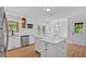 Bright and modern kitchen with white cabinetry, stainless appliances and kitchen island at 1731 Maryland Sw Ave, Marietta, GA 30008