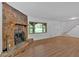 Spacious living room with a stone fireplace, hardwood floors, and a large window at 1731 Maryland Sw Ave, Marietta, GA 30008