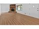 Spacious living room with wood floors, a stone fireplace, and abundant natural light at 1731 Maryland Sw Ave, Marietta, GA 30008