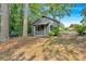 Cozy outbuilding with a covered porch, offering a quiet retreat surrounded by trees and foliage at 1731 Maryland Sw Ave, Marietta, GA 30008
