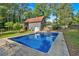 Inviting backyard pool with a slide and a clear view of the house, surrounded by mature trees at 1731 Maryland Sw Ave, Marietta, GA 30008