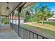 Covered porch area with a view of the lush backyard and detached garage at 1731 Maryland Sw Ave, Marietta, GA 30008