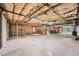 Unfinished basement with exposed insulation, lighting, concrete floors, and a door to the outside at 245 Sutallee Ridge Ne Ln, White, GA 30184