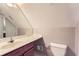 Bathroom with marble-look vanity and a mirror, alongside a toilet and glass-enclosed shower at 245 Sutallee Ridge Ne Ln, White, GA 30184