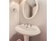 Bathroom features pedestal sink, oval mirror, updated fixture, and grey paint at 245 Sutallee Ridge Ne Ln, White, GA 30184