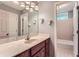 Updated bathroom with cherry cabinet, quartz counter and tile floors, with secondary bath in view at 245 Sutallee Ridge Ne Ln, White, GA 30184