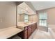 Bathroom with double sinks, vanity, granite counters, tile floors, and window at 245 Sutallee Ridge Ne Ln, White, GA 30184