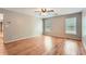 Large bedroom with hardwood floors, ceiling fan, 2 large windows, and neutral color paint at 245 Sutallee Ridge Ne Ln, White, GA 30184