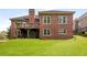 Spacious backyard with a brick house, wooden deck, and play area at 4457 Equity Ct, Ellenwood, GA 30294