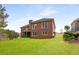 Expansive backyard with a brick two-story home and wooden deck at 4457 Equity Ct, Ellenwood, GA 30294