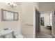 Bathroom with a pedestal sink, toilet, and accessibility features at 4457 Equity Ct, Ellenwood, GA 30294