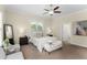 Bedroom features carpet, a ceiling fan, two bedside tables, and a bench at the foot of the bed at 4457 Equity Ct, Ellenwood, GA 30294