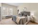 Bedroom with a gray upholstered bed, a bench, and large window at 4457 Equity Ct, Ellenwood, GA 30294