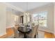 Elegant dining room with hardwood floors, modern chandelier, and bright natural light at 4457 Equity Ct, Ellenwood, GA 30294