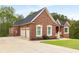 Brick home with a long driveway and two-car garage at 4457 Equity Ct, Ellenwood, GA 30294