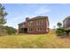 Two-story brick home with a well-manicured lawn and a backyard swing set at 4457 Equity Ct, Ellenwood, GA 30294