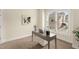 Bright office with large window, modern desk, and neutral carpet at 4457 Equity Ct, Ellenwood, GA 30294
