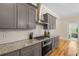 Gourmet kitchen showcases granite countertops, stainless steel appliances, and subway tile backsplash at 4457 Equity Ct, Ellenwood, GA 30294