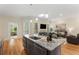 Modern kitchen boasts granite countertops, stainless steel appliances, and an island with bar seating at 4457 Equity Ct, Ellenwood, GA 30294