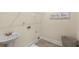 Laundry room featuring a pedestal sink, tile floors, and laundry room signage at 4457 Equity Ct, Ellenwood, GA 30294