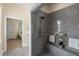 Accessible tiled shower featuring built in seating, safety bars and an adjustable shower head at 4457 Equity Ct, Ellenwood, GA 30294