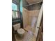 Bathroom featuring a tiled shower, toilet and small window at 1471 Ashwood Way, Lawrenceville, GA 30043