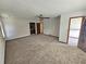 Large bedroom features a ceiling fan, large doorway and neutral carpet at 1471 Ashwood Way, Lawrenceville, GA 30043