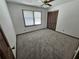 Bedroom featuring neutral carpet, a ceiling fan, window and a closet at 1471 Ashwood Way, Lawrenceville, GA 30043