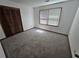 Bedroom featuring neutral carpet, a window, closet and natural light at 1471 Ashwood Way, Lawrenceville, GA 30043