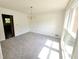 A simple dining room features new carpet and a large window at 1471 Ashwood Way, Lawrenceville, GA 30043