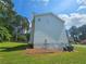 Side view of the home's exterior with a well-maintained yard and mature trees at 1471 Ashwood Way, Lawrenceville, GA 30043