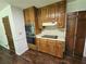 The kitchen features warm cabinets, an oven, and cooktop at 1471 Ashwood Way, Lawrenceville, GA 30043