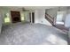 Spacious living room with new carpeting, a brick fireplace, lots of natural light, and a staircase with wood railing at 1471 Ashwood Way, Lawrenceville, GA 30043
