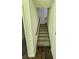 Carpeted staircase with white walls and a wooden railing at 1471 Ashwood Way, Lawrenceville, GA 30043