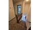 Carpeted stairway with wood railing leading to the entry of the home at 1471 Ashwood Way, Lawrenceville, GA 30043