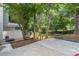 Lush backyard featuring a concrete patio, mature trees, and a small trampoline, perfect for outdoor enjoyment at 2320 Boone Pl, Snellville, GA 30078
